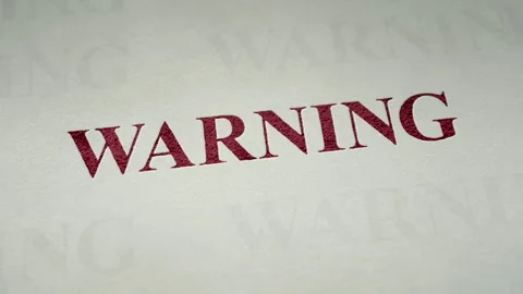 Red Warning Text Typed onto White Paper 库存影片 265762537