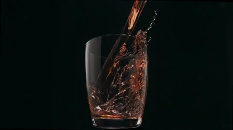 Red water pouring into glass, Slow Motion Stock Footage