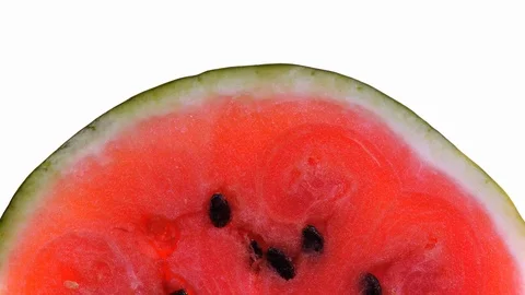 Red watermelon rotates on white background with free place for your text in 4K Vídeos de archivo 89869359