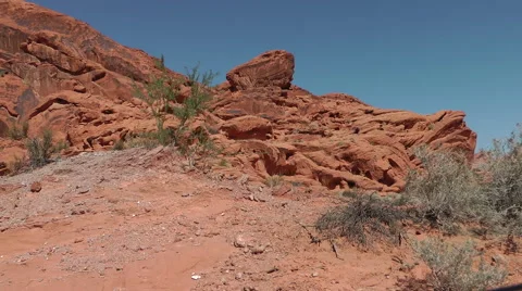 Red wavy rocks of Valley of Fire State park, NE in bright sunny day Video stock 60022390