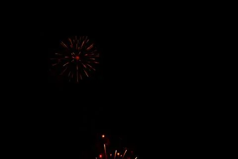 Red weeping firework exploding in the night sky Stock Photos