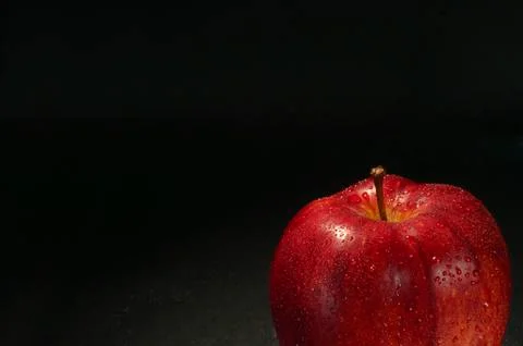 Red wet apple with drops Stock Photos