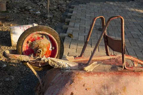 Red wheelbarrow is placed upside down Stock Photos