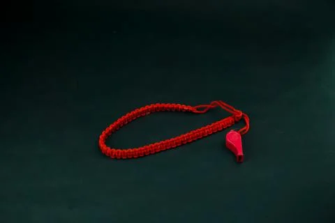 Red Whistle blower isolated against black background Stock Photos