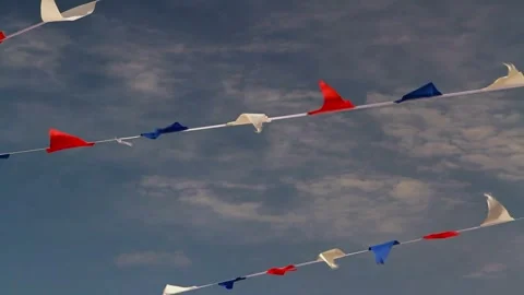 Red white and blue bunting fluttering against summer sky with some cloud Stock Footage 296710850
