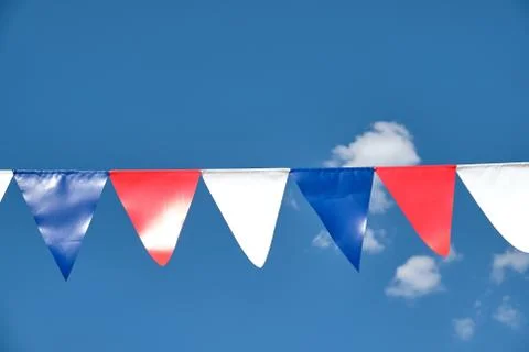 Red white and blue triangular bunting on sky background Stock Photos