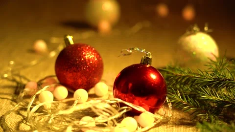Red, White Balls, Coniferous Branches and Garlands of Yellow Lamps Lie on a Stock Footage 142270725