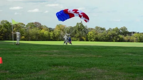 Red, White, Blue Parachutist lands with American Flag at Flying Circus Show Stock Footage
