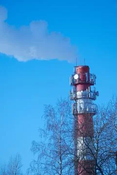 Red-white chimney on the background of clear sky Stock Photos