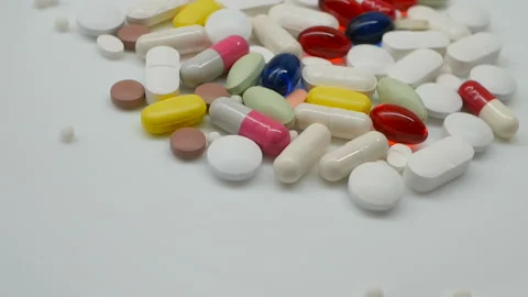 Red, white, colored pills rotating, from the right side 動画素材 85742677