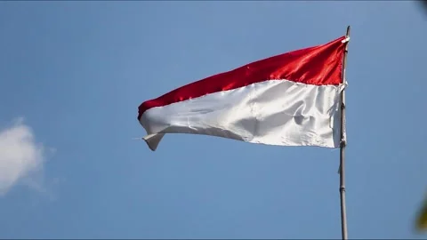 Red White Flag. Flag of the republic indonesia with blue sky as background Stock Footage 246893193