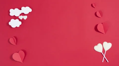 Red, white hearts and clouds appears on a red background. Greeting card.  Stock Footage 260545312