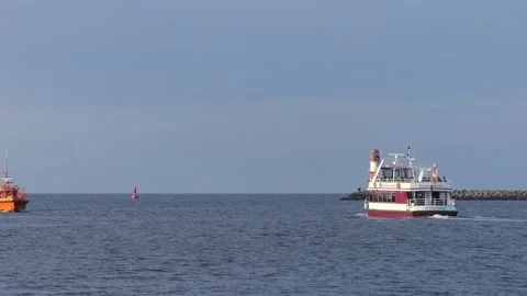 Red white lighthouse at the baltic sea in Rostock harbor with ships Stock Footage 140670170