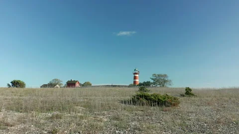 Red &amp; white lighthouse. Beauitful area on the island of Närsholmen, Gotland Stock Footage 142061981