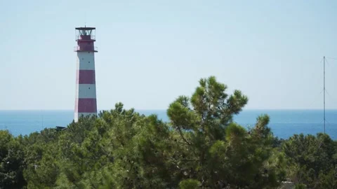 Red white lighthouse at the top of the mountain. Stock Footage 145728546
