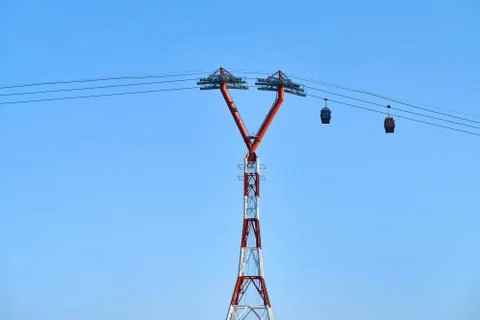Red-white ropeway with two moving colorful cabins Foto stock