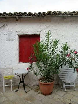 A red window and pot with red flowers Stock Photos