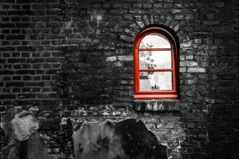 Red window on a brick wall in black and white Stock Photos