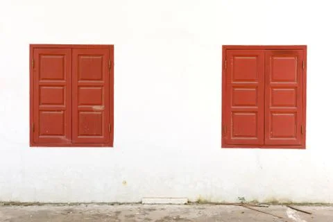 Red windows on white wall Stock Photos