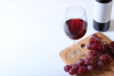 Red wine and grapes on the table top view. Stock Photos