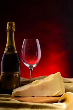 Red wine, assorted cheeses, bread and grapes in a still life setup Stock Photos