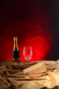 Red wine, assorted cheeses, bread and grapes in a still life setup Stock Photos