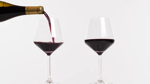 Red wine being poured into 2 glasses Stock Footage 240848146
