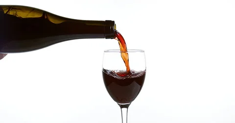Red Wine being poured into Glass, against White Background, Slow motion 4K Stock Footage