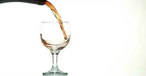 Red Wine being poured into Glass, against White Background, Slow motion 4K Stock Footage