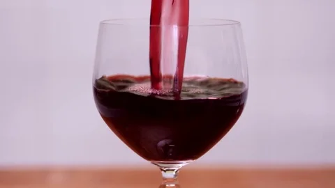 Red wine being pured into a crystal glass - 4K Stock Footage 74219888
