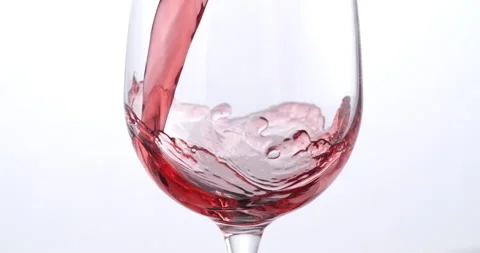 Red wine is being swirled in transparent glass for quality check in wine cellar Stock Footage 268471014