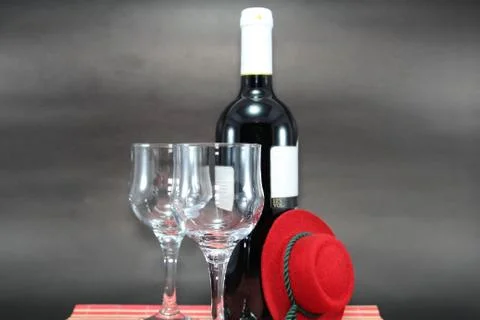 Red Wine Bottle With Empty Label and Two Glasses Isolated on Black Background Stock Photos