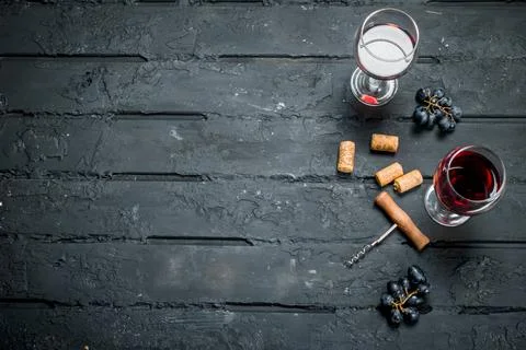 Red wine with corkscrew. Stock Photos