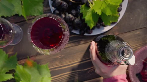 Red Wine In Crystal Glasses, Romantic Date, Fresh Grape Clusters. Woman taking b Stock Footage 337326881