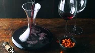 Red Wine Is Decanted Next To Cashew Nuts Stock Footage