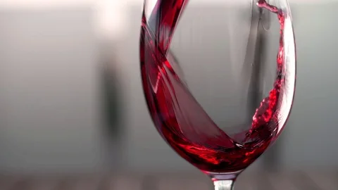 Red wine forms a beautiful wave in a glass fuse Stock Footage 102653098