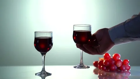 Red wine forms beautiful wave. Wine pouring in wine glass over white background Stock Footage 156246309