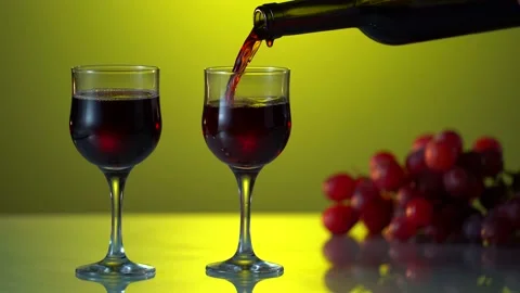 Red wine forms beautiful wave. Wine pouring in wine glass at dramatic background Stock Footage 162231330