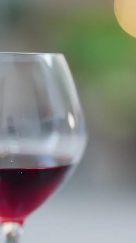 Red Wine Glass in Soft Focus at Outdoor Dining Table 库存影片 315725909