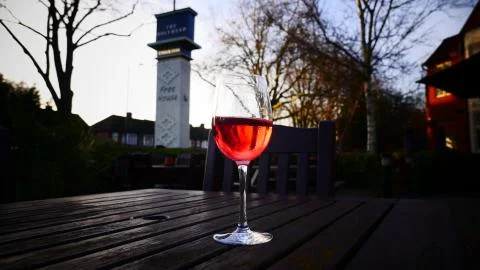 Red wine glass at the table out side pub  Stock Photos