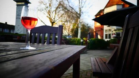 Red wine glass at the table Stock Photos