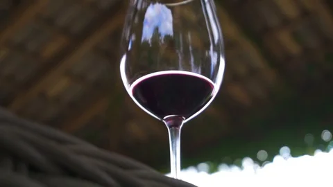Red wine in glass on wicker table at summer terrace, Napa Valley degustation Stock Footage 129266296
