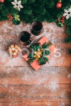 Red wine in glasses prepared with present boxes on snow wood board, pine bran Stock Photos