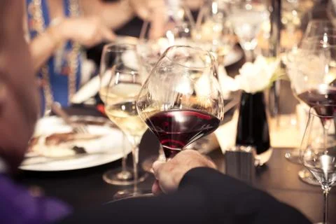 Red wine on hand with dinner on restaurant Stock Photos