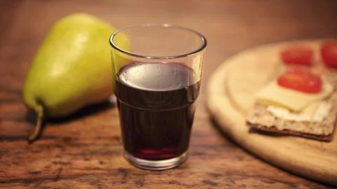 Red wine with pear and bread on wooden table Stock-Fotos