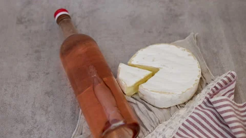 Red wine pour flows from bottle in glass gray tiles background Stock Footage 239303203