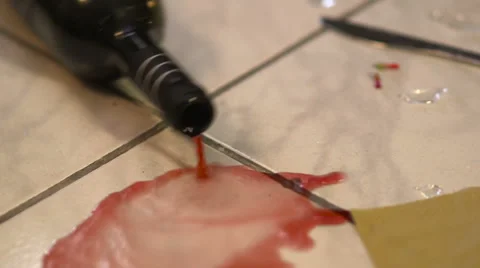 Red wine poured from a bottle that rolls on the floor Stock Footage 52432064