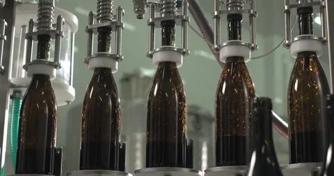 Red wine poured into bottles by the machine. Close-up shot of filling bottles Stock Footage 265612811