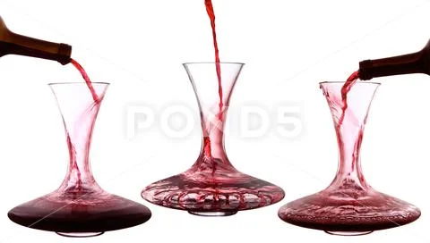 Red wine poured into decanter Stock Photos