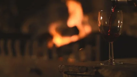 Red Wine Poured in Front of a Log Fire Stock Footage 78024903